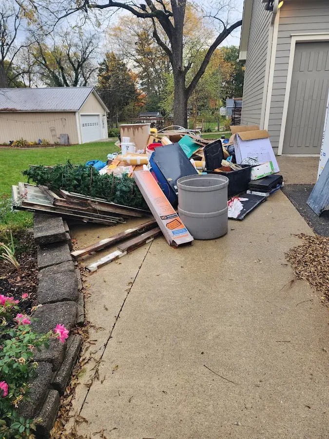 Dumpster being loaded with debris for Estate Cleanout Dumpster Rental in Huron